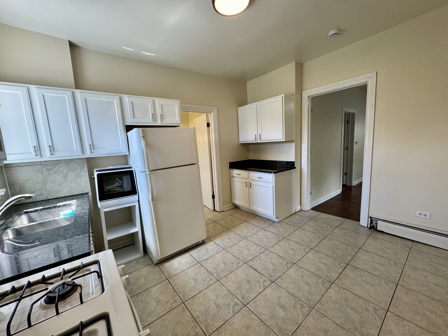 844 Deerfield Road, Unit 2 Highland Park, IL 60035 - Photo 6 of 18 a kitchen with stainless steel appliances granite countertop a refrigerator stove and sink