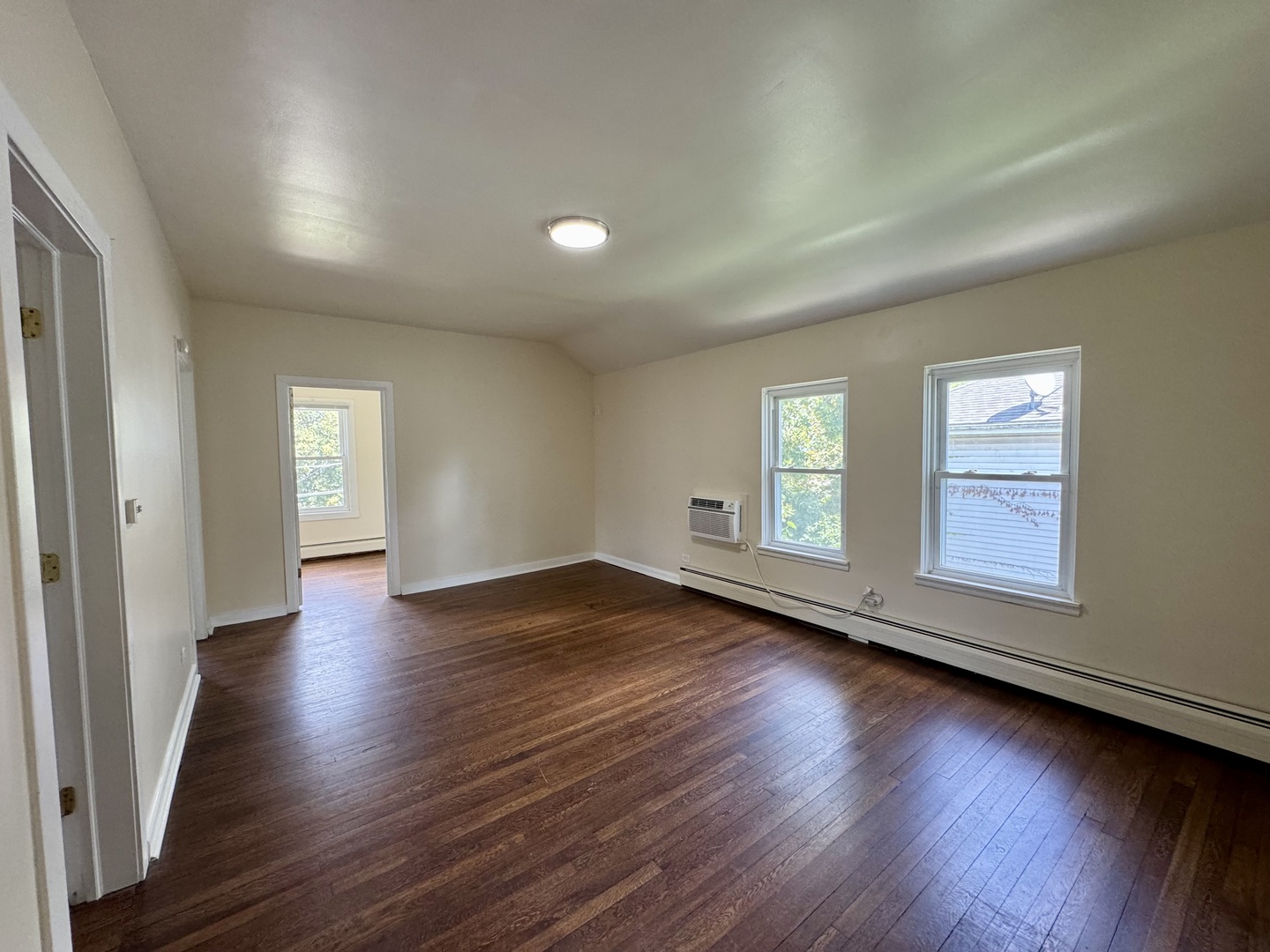 844 Deerfield Road, Unit 2 Highland Park, IL 60035 - Photo 9 of 18 an empty room with wooden floor and windows