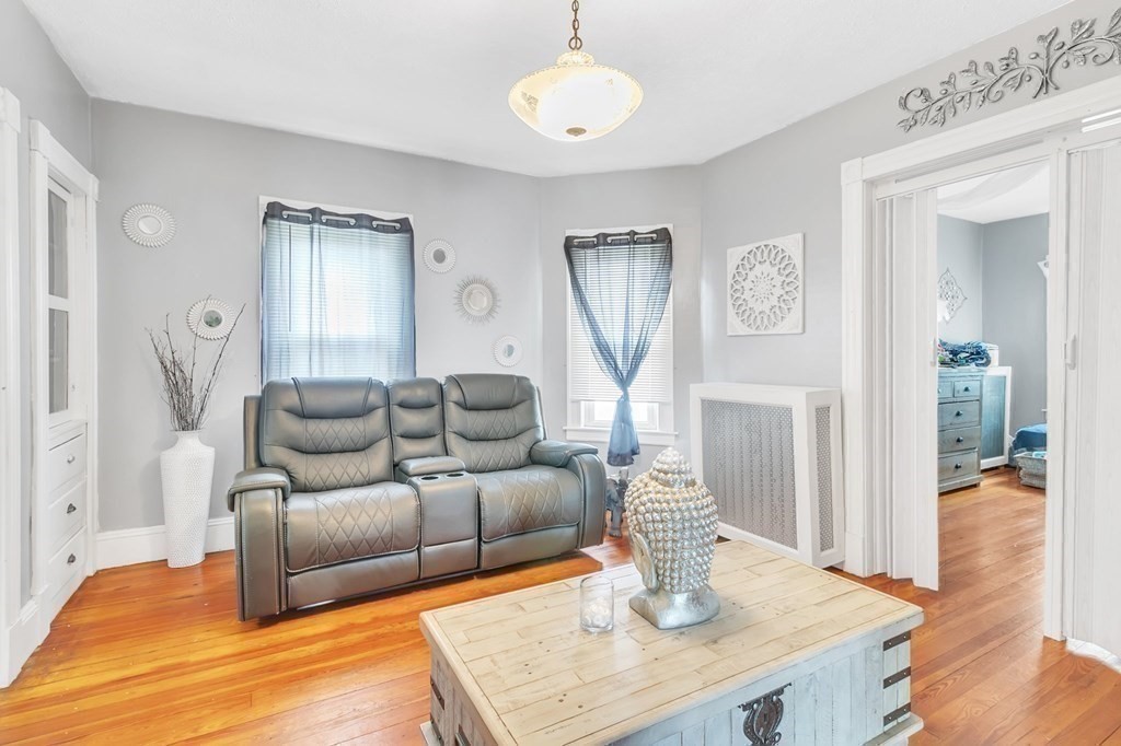 18 Porter Street Springfield, MA 01104 - Photo 22 of 42 a living room with furniture a fireplace and a table