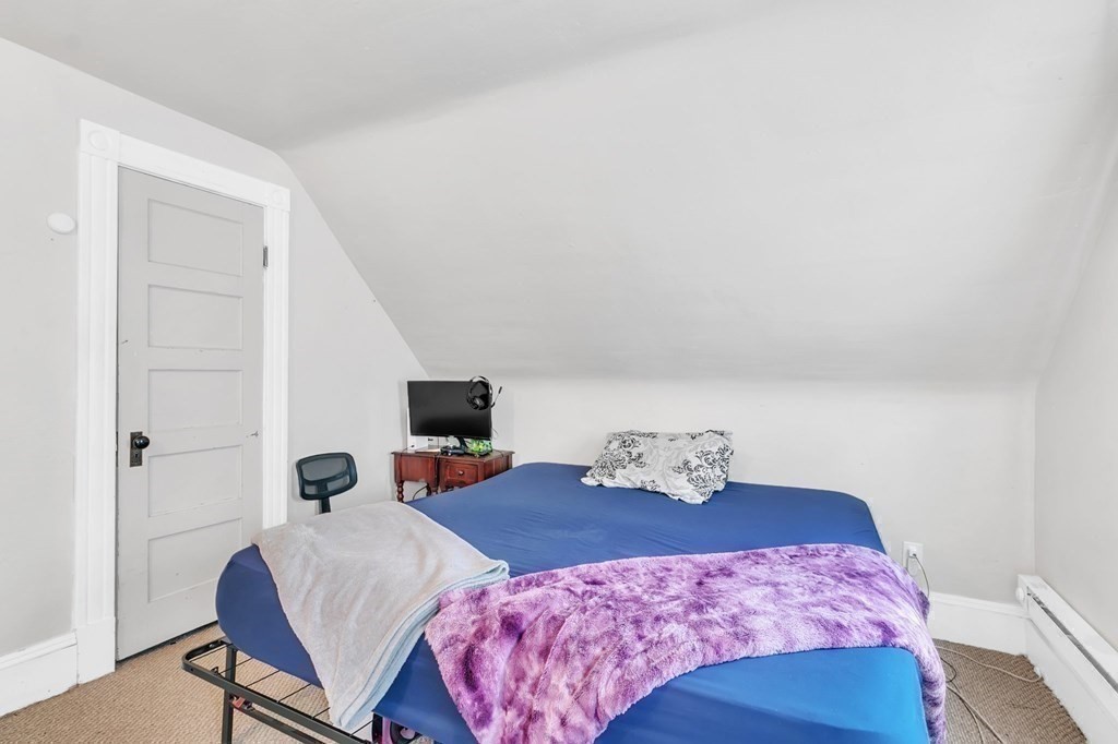18 Porter Street Springfield, MA 01104 - Photo 32 of 42 a bedroom with a bed and wooden floor