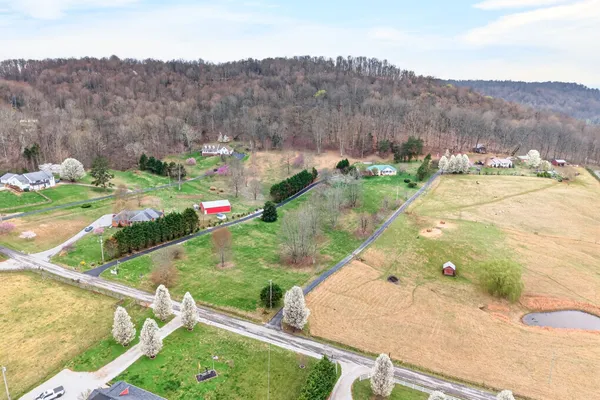 an aerial view of residential houses with outdoor space and swimming pool