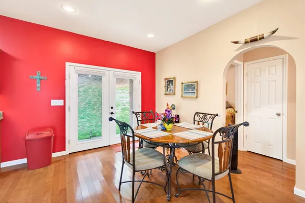 a dining room with furniture and wooden floor