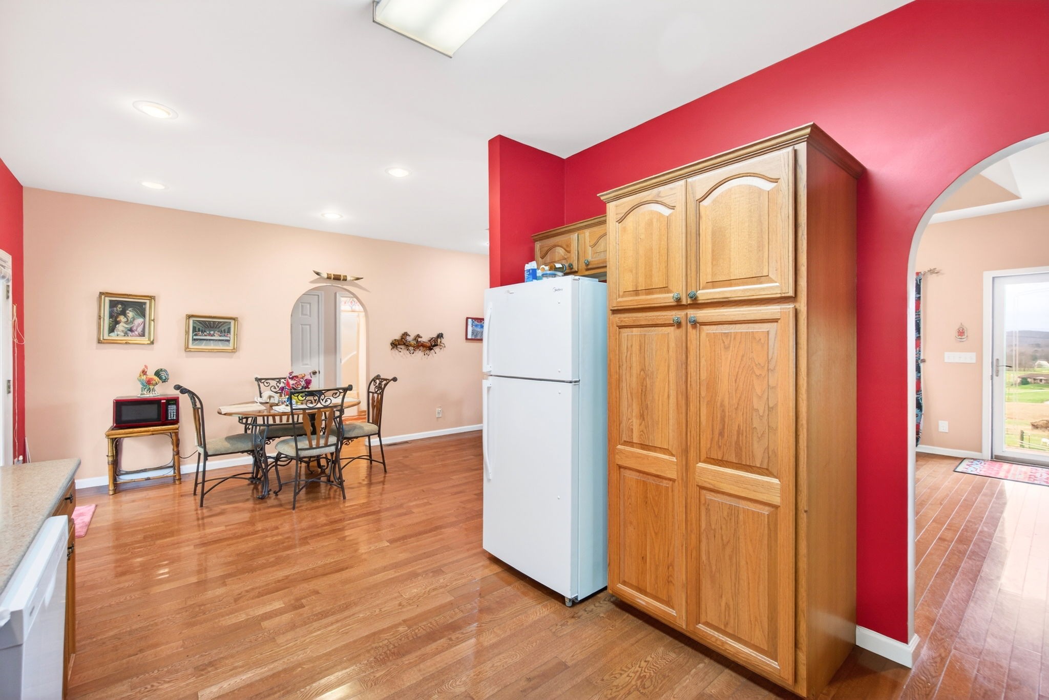 444 Mackie Road Sparta, TN 38583 - Photo 6 of 31 a kitchen with stainless steel appliances granite countertop a refrigerator a microwave oven a dining table and chairs with wooden floor