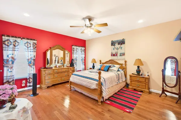 a bedroom with bed and a chandelier