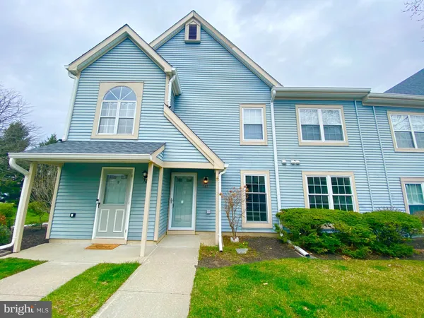 a front view of a house with a yard and porch