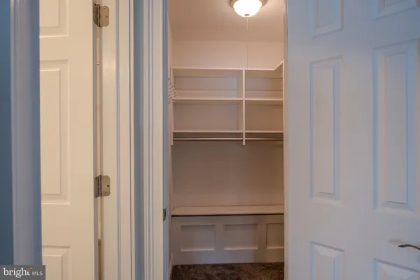 an empty room with closet area