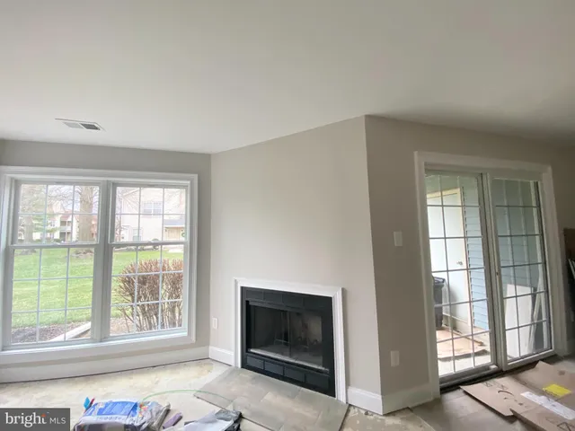 a front view of house with garden and trees