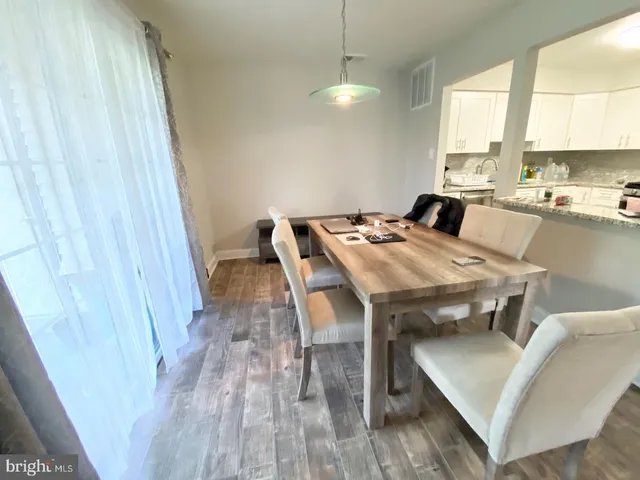 a front view of a house with a garden and yard