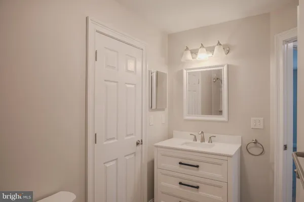 a front view of house with garden and trees