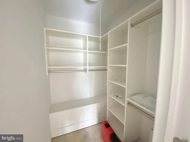 a living room with a fireplace and large windows