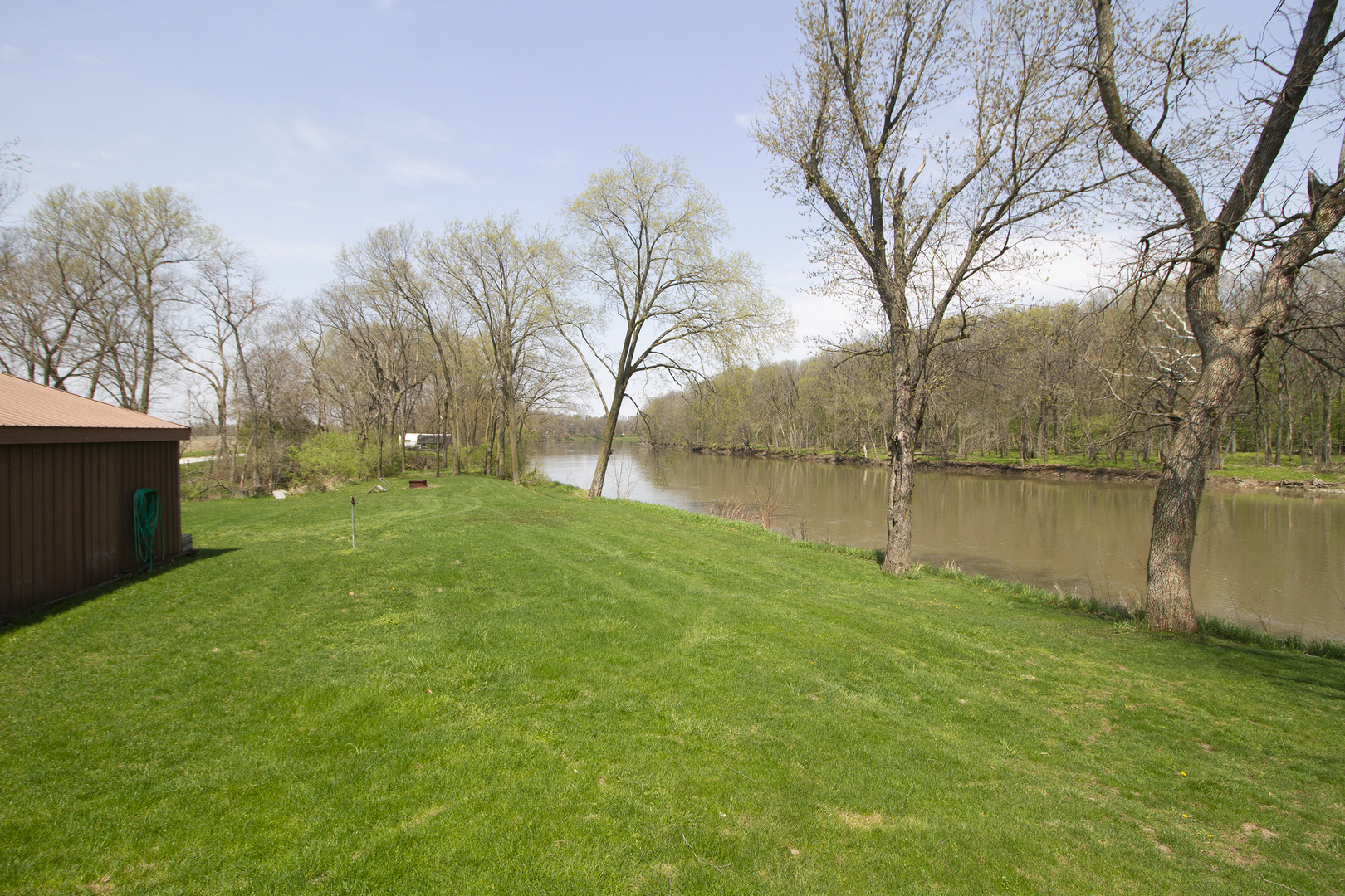 5585 River Road Kankakee, IL 60901 - Photo 19 of 30 a backyard of a house with lots of green space and lake view