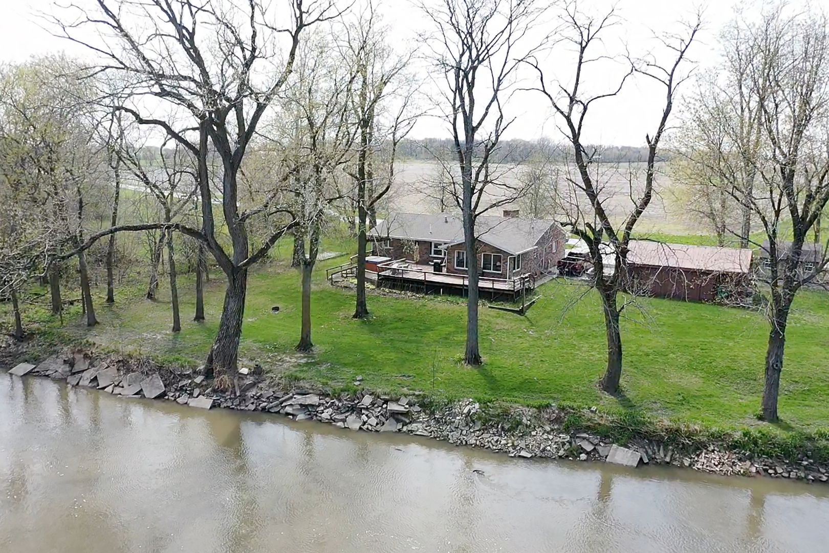 5585 River Road Kankakee, IL 60901 - Photo 28 of 30 a view of a lake with a yard and large trees