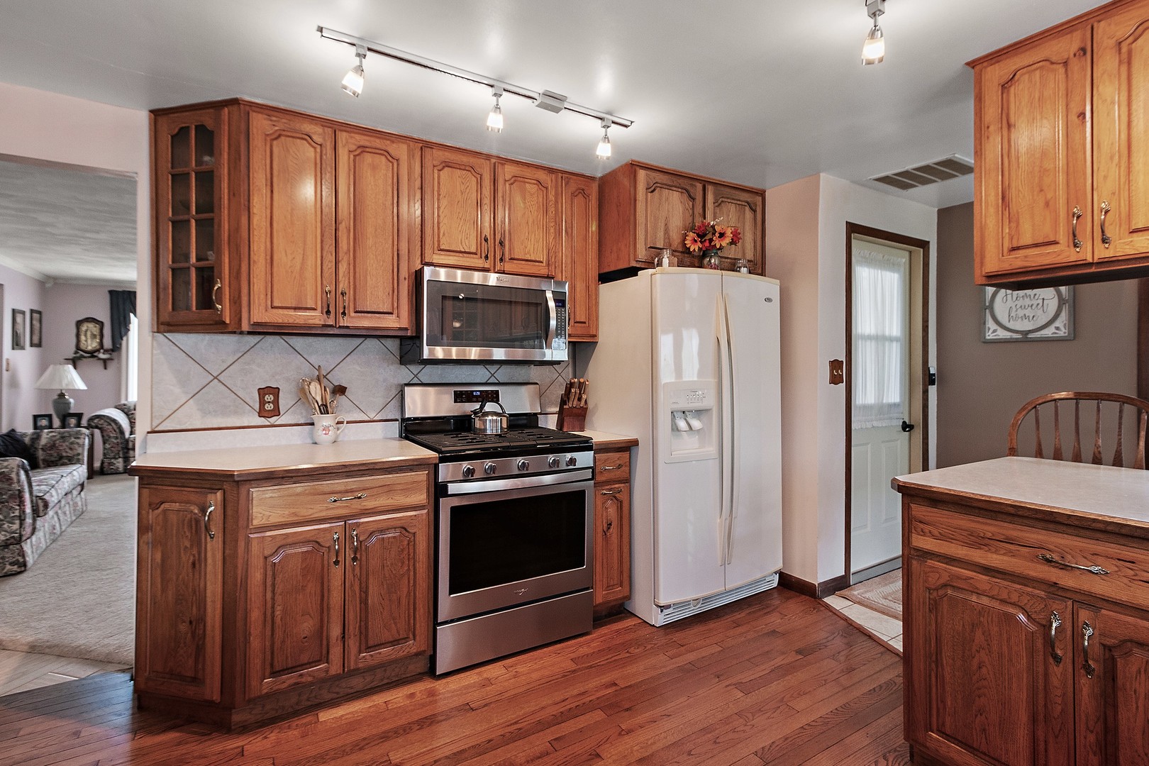 5585 River Road Kankakee, IL 60901 - Photo 6 of 30 a kitchen with stainless steel appliances granite countertop a refrigerator stove a sink and dishwasher with wooden floor
