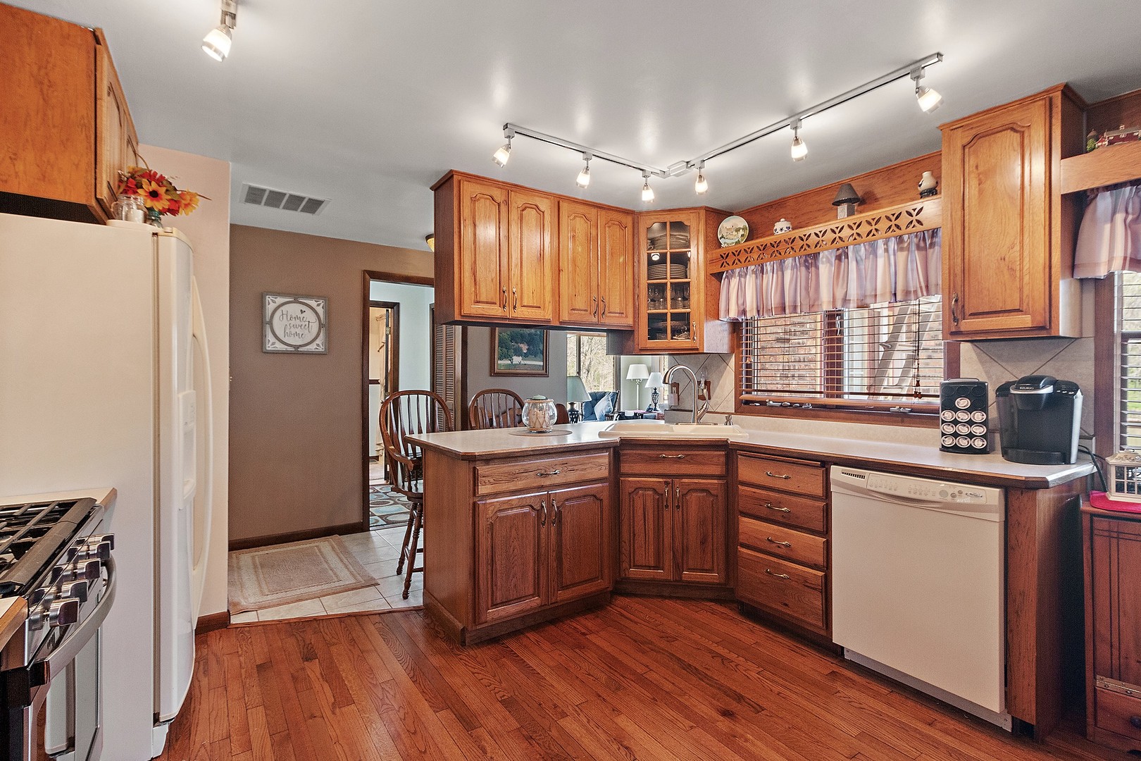 5585 River Road Kankakee, IL 60901 - Photo 8 of 30 a kitchen with stainless steel appliances granite countertop wooden cabinets a sink and dishwasher a refrigerator with wooden floor