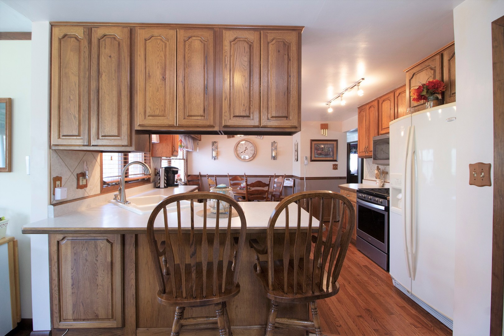 5585 River Road Kankakee, IL 60901 - Photo 9 of 30 a kitchen with stainless steel appliances sink refrigerator dining table and chairs