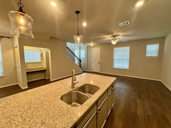 a kitchen with stainless steel appliances granite countertop a sink a oven and a dining table