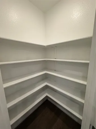 a view of a room with wooden floor and windows