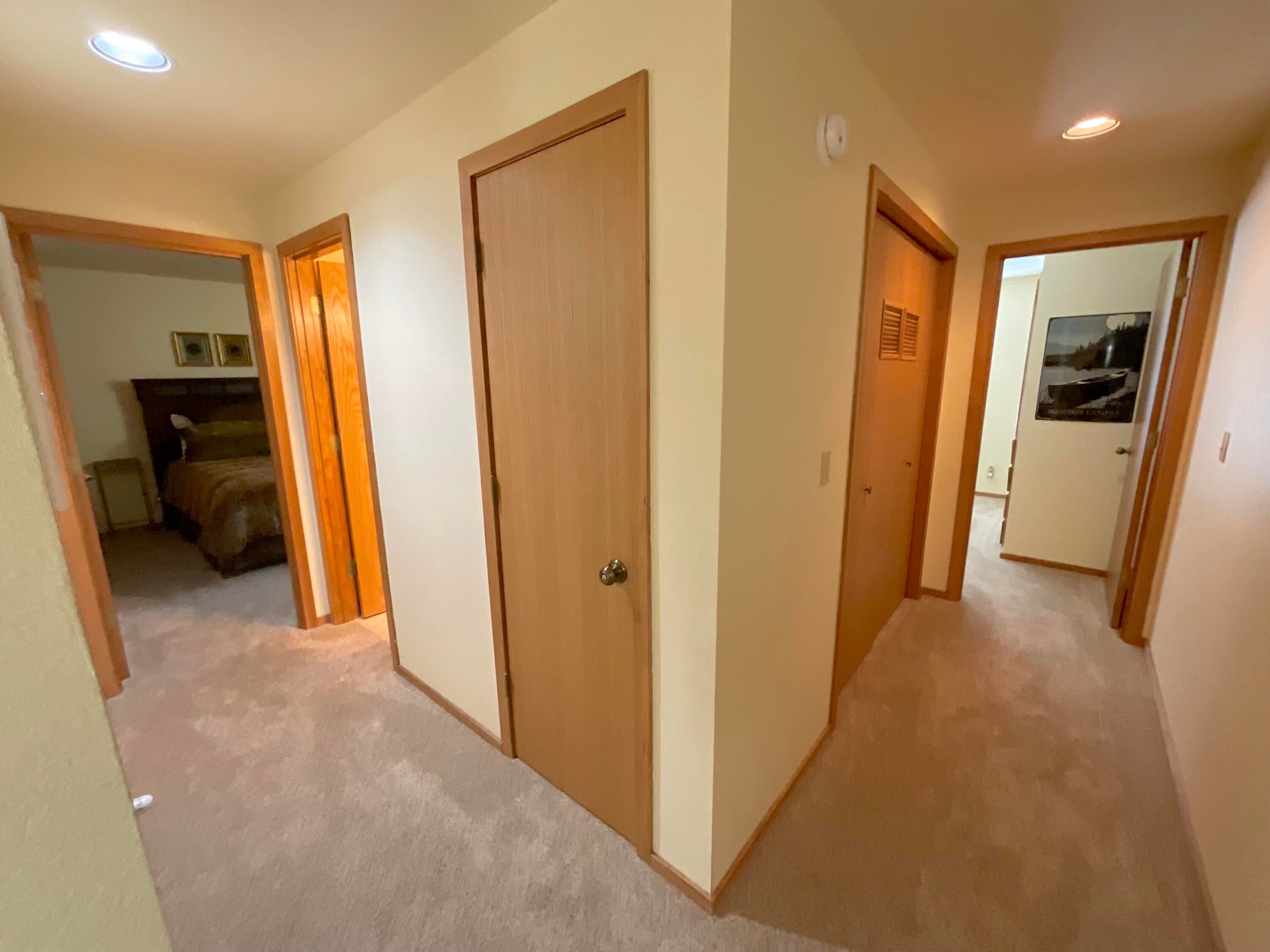 17854 West Core Road Sunriver, OR 97707 - Photo 16 of 26 Left-to-right: stairs and garage access, owners closet, washer/dryer and the other two bedrooms.