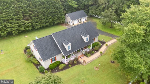 an aerial view of a house with a yard and swimming pool