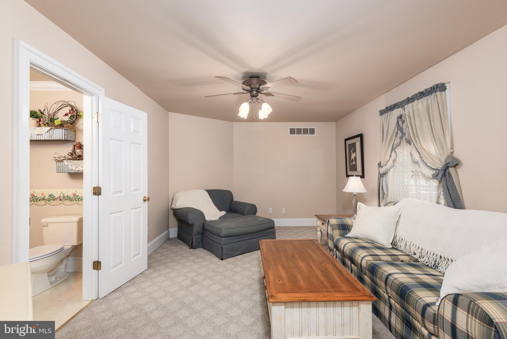 1002 Burrisville Road Centreville, MD 21617 - Photo 18 of 50 a living room with furniture and a chandelier