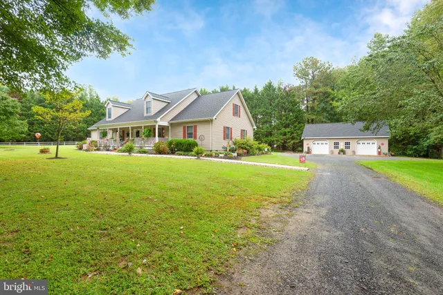 a view of house with yard in front of house