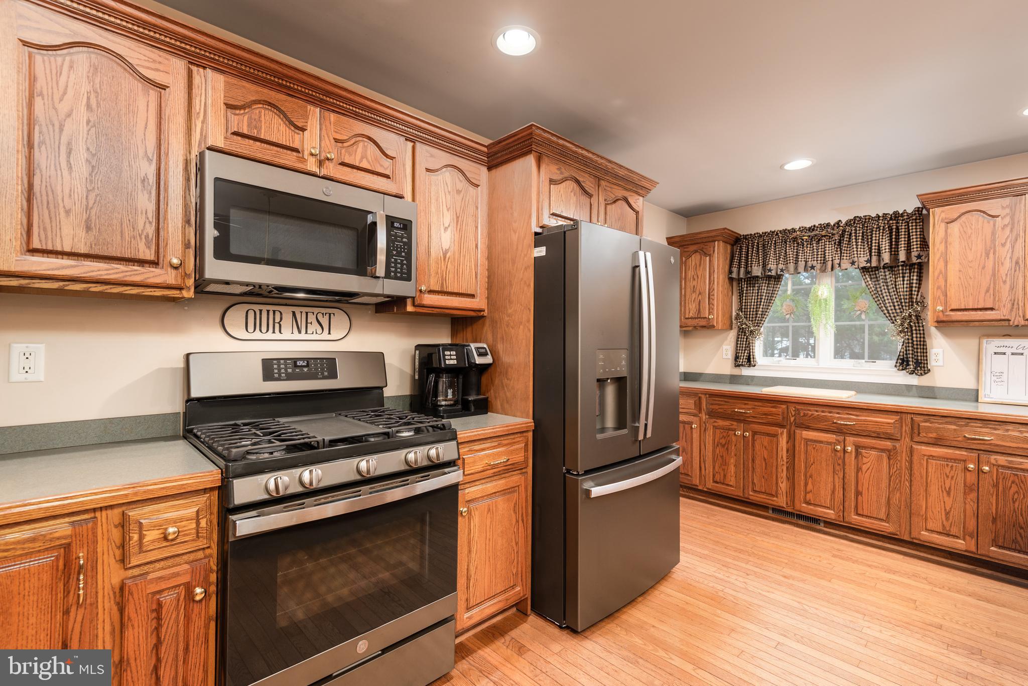 1002 Burrisville Road Centreville, MD 21617 - Photo 21 of 50 a kitchen with stainless steel appliances granite countertop a refrigerator stove and microwave
