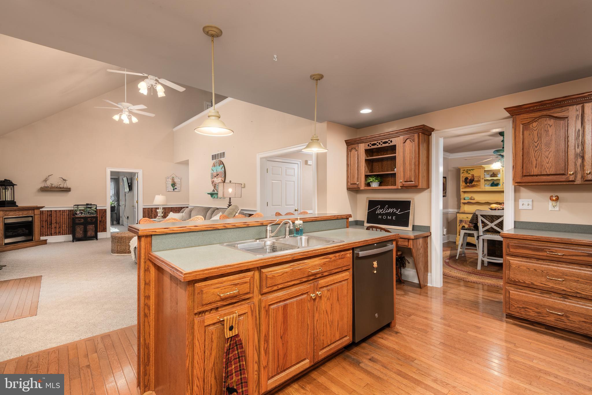 1002 Burrisville Road Centreville, MD 21617 - Photo 22 of 50 a kitchen with stainless steel appliances granite countertop a sink a stove and a wooden floors