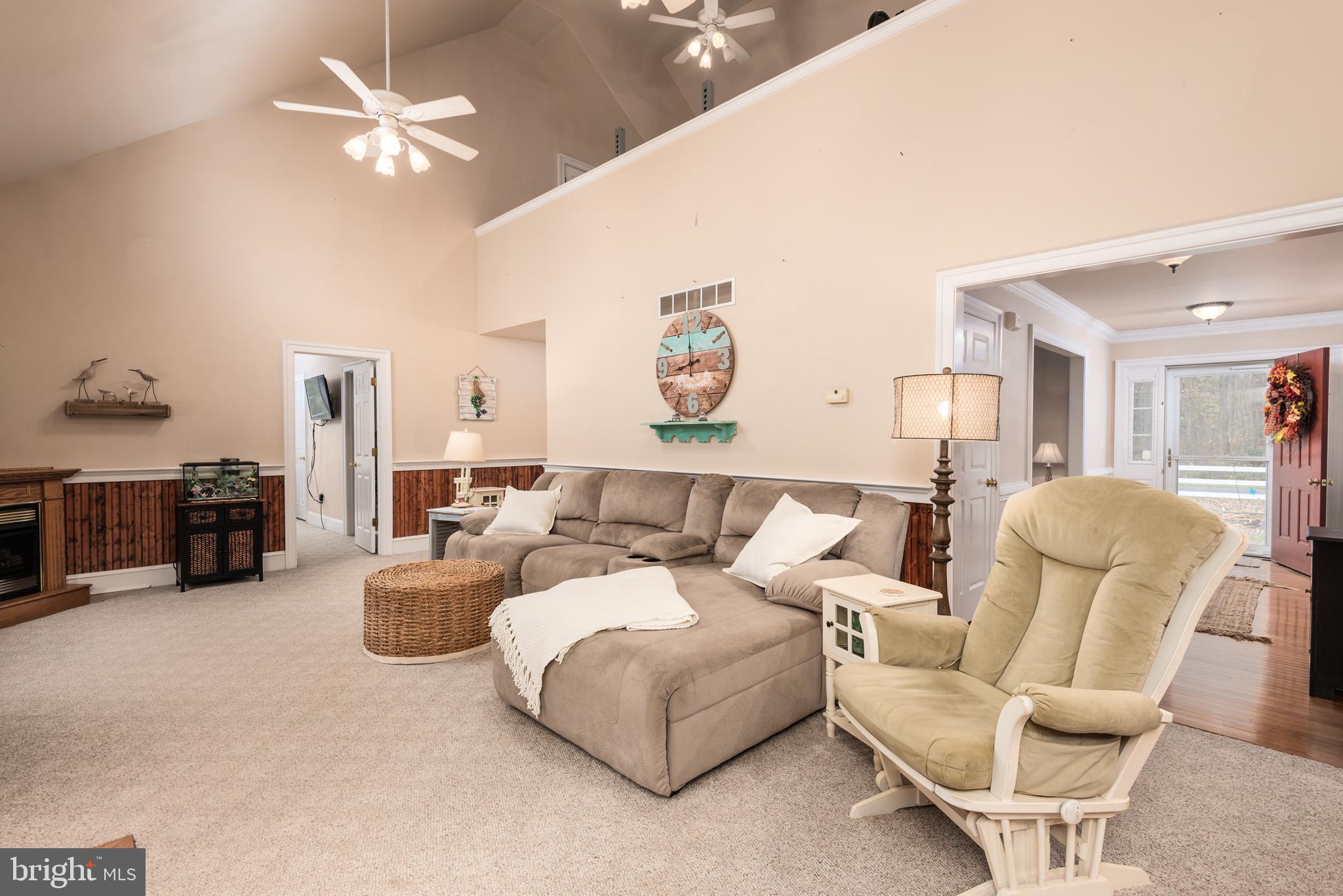1002 Burrisville Road Centreville, MD 21617 - Photo 23 of 50 a living room with furniture and a chandelier