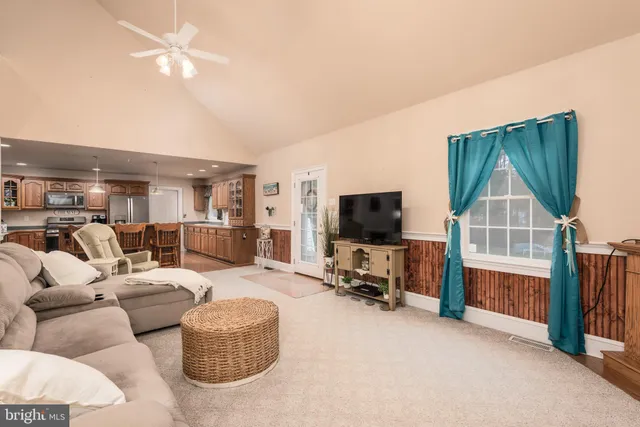 a living room with furniture and a book shelf
