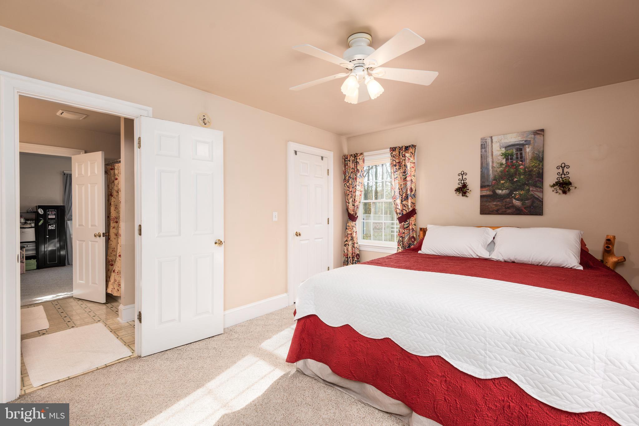 1002 Burrisville Road Centreville, MD 21617 - Photo 35 of 50 a bedroom with a bed and a chandelier
