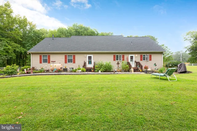 a front view of house with yard and outdoor seating