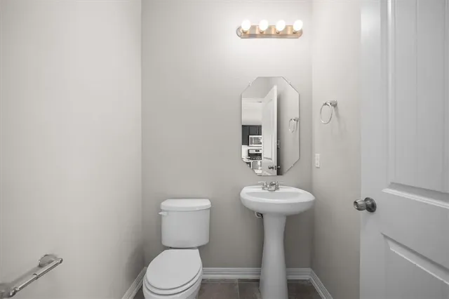 a bathroom with a sink a mirror and a toilet