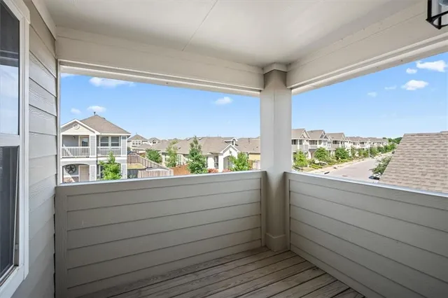 a view of roof deck with wooden floor and seating space