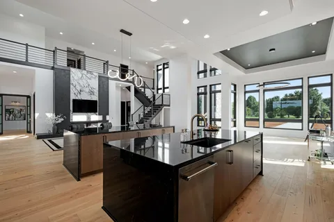 a bathroom with a granite countertop sink a toilet and mirror