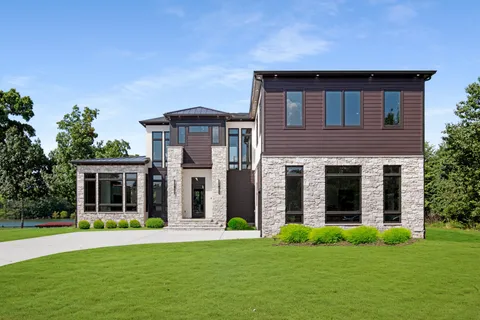 a front view of a house with a yard and garage