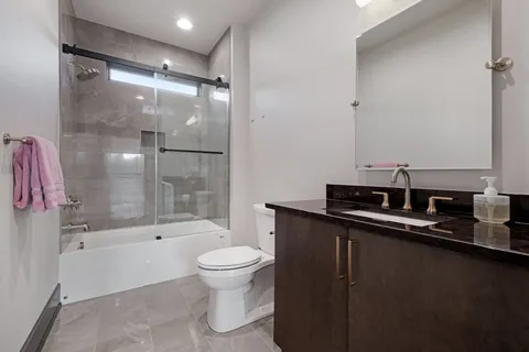 a view of a living room filled with furniture and windows