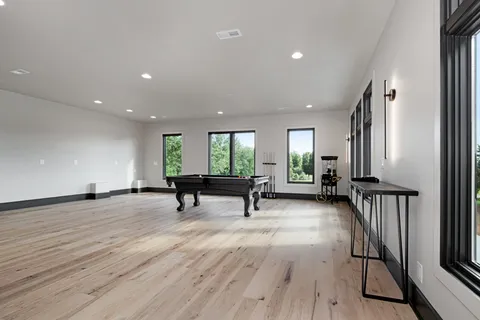 an empty room with window wooden floor and windows