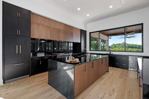 a kitchen with counter top space and living room