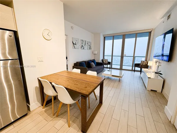 a dining room with wooden floor and a table