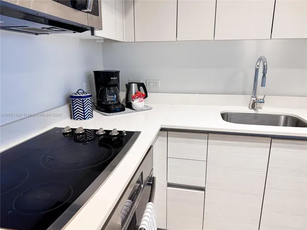 a kitchen with sink and cabinets