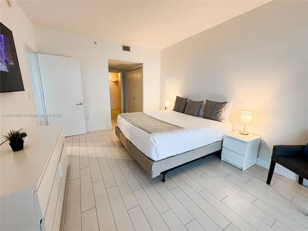 a bedroom with a bed and a chair