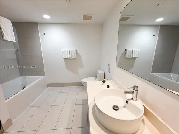 a bathroom with a bathtub and a sink