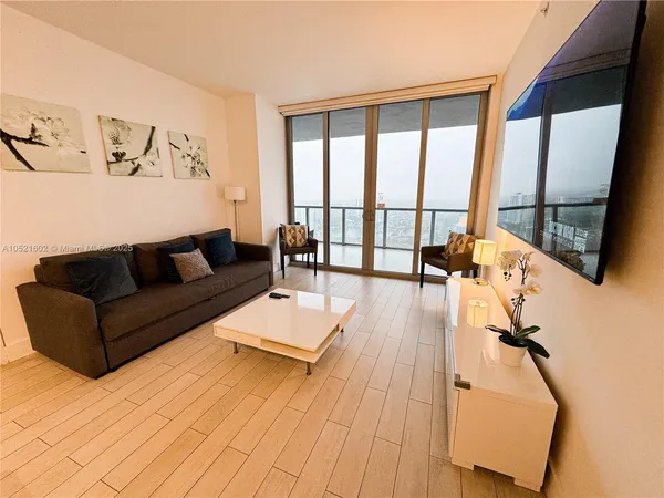 a living room with furniture and a large window