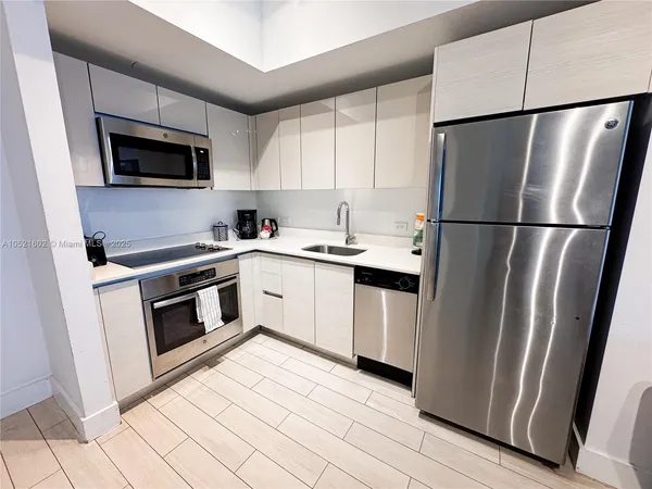 a kitchen with a refrigerator sink and microwave