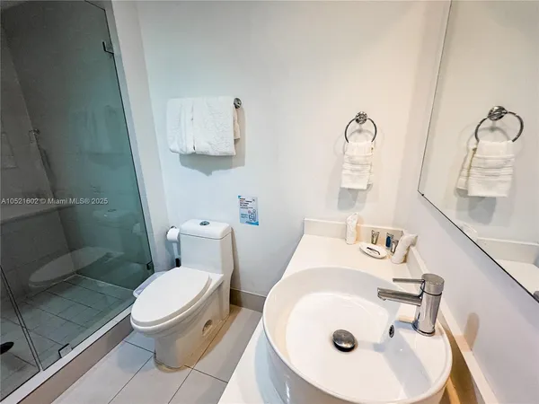 a bathroom with a sink toilet and mirror