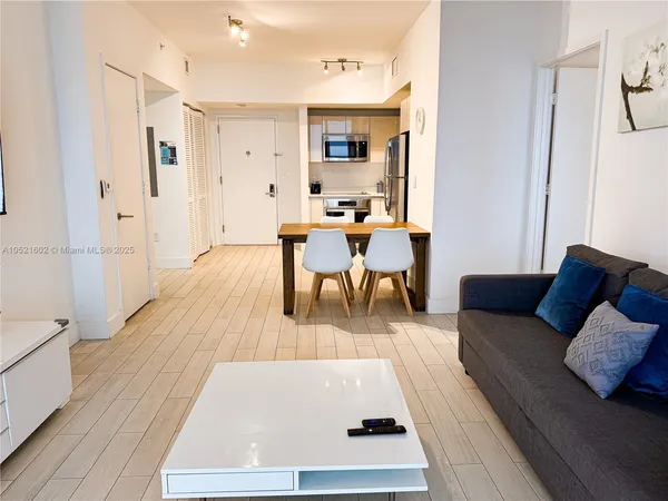 a living room with furniture and a wooden floor
