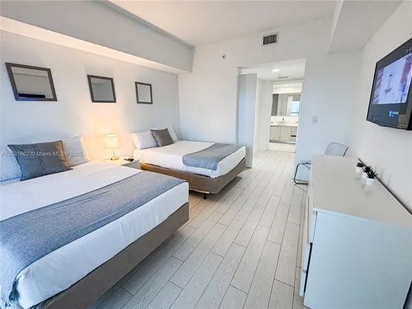 a bedroom with two beds and painted walls