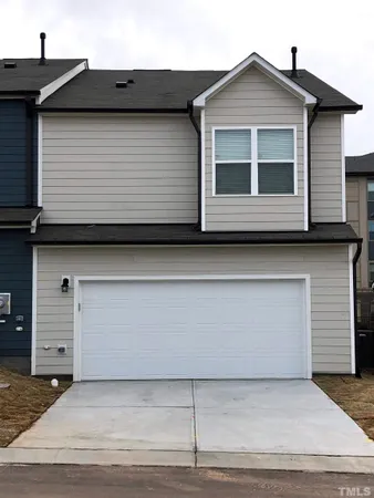 a front view of a house with garage