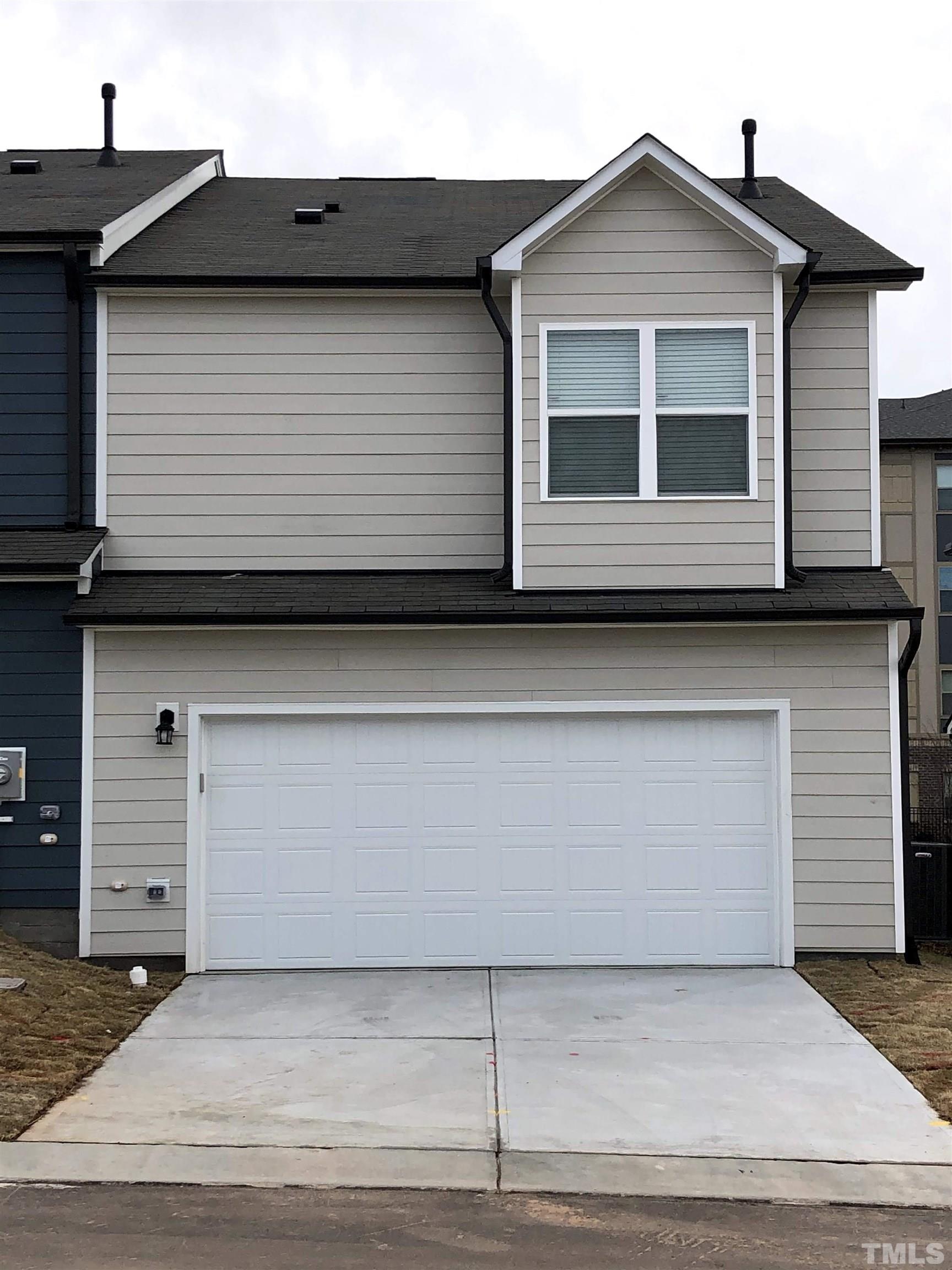 1215 Merrion Avenue Durham, NC 27703 - Photo 1 of 19 a front view of a house with garage