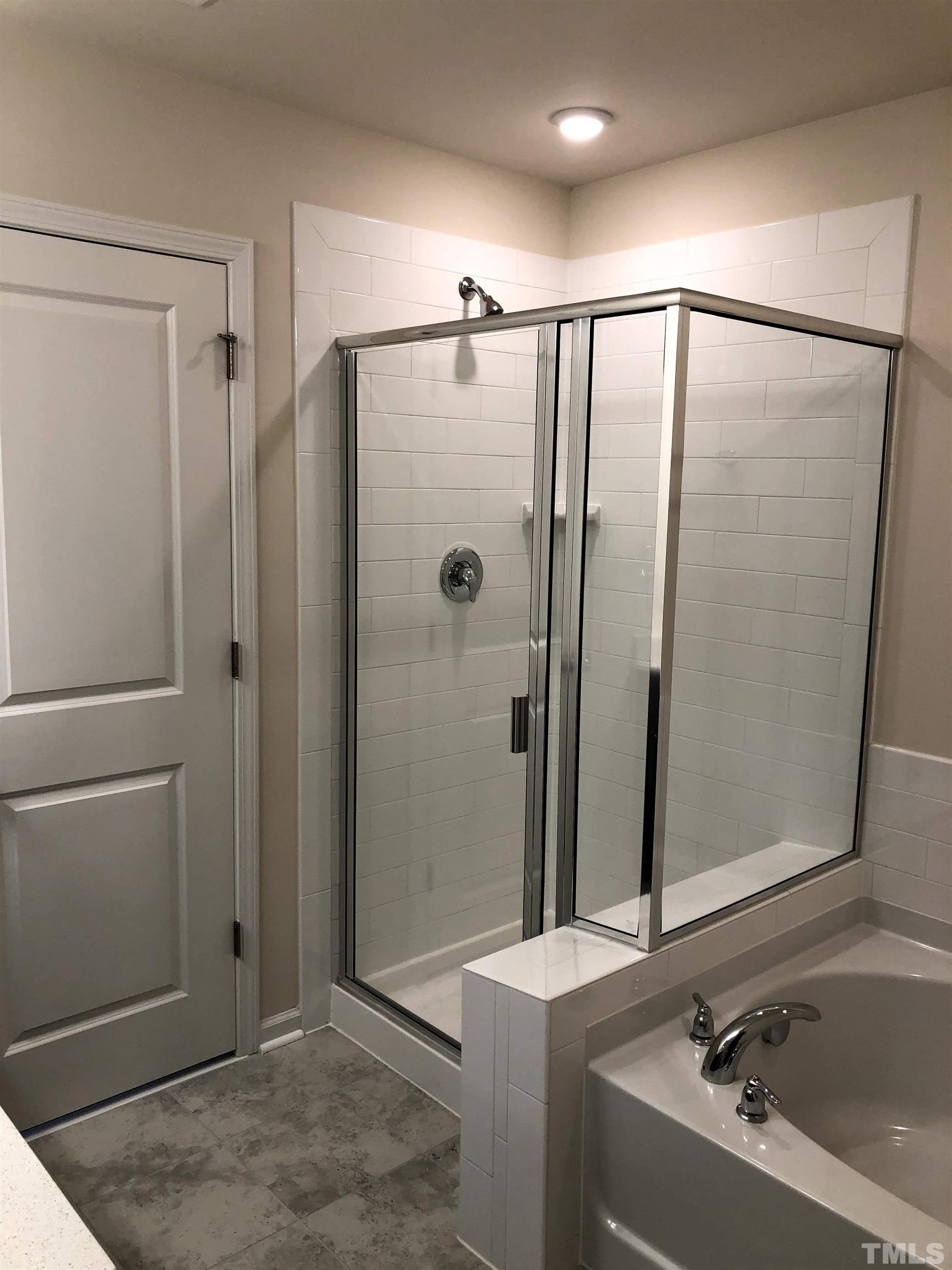 1215 Merrion Avenue Durham, NC 27703 - Photo 12 of 19 a bathroom with a tub a sink and a mirror